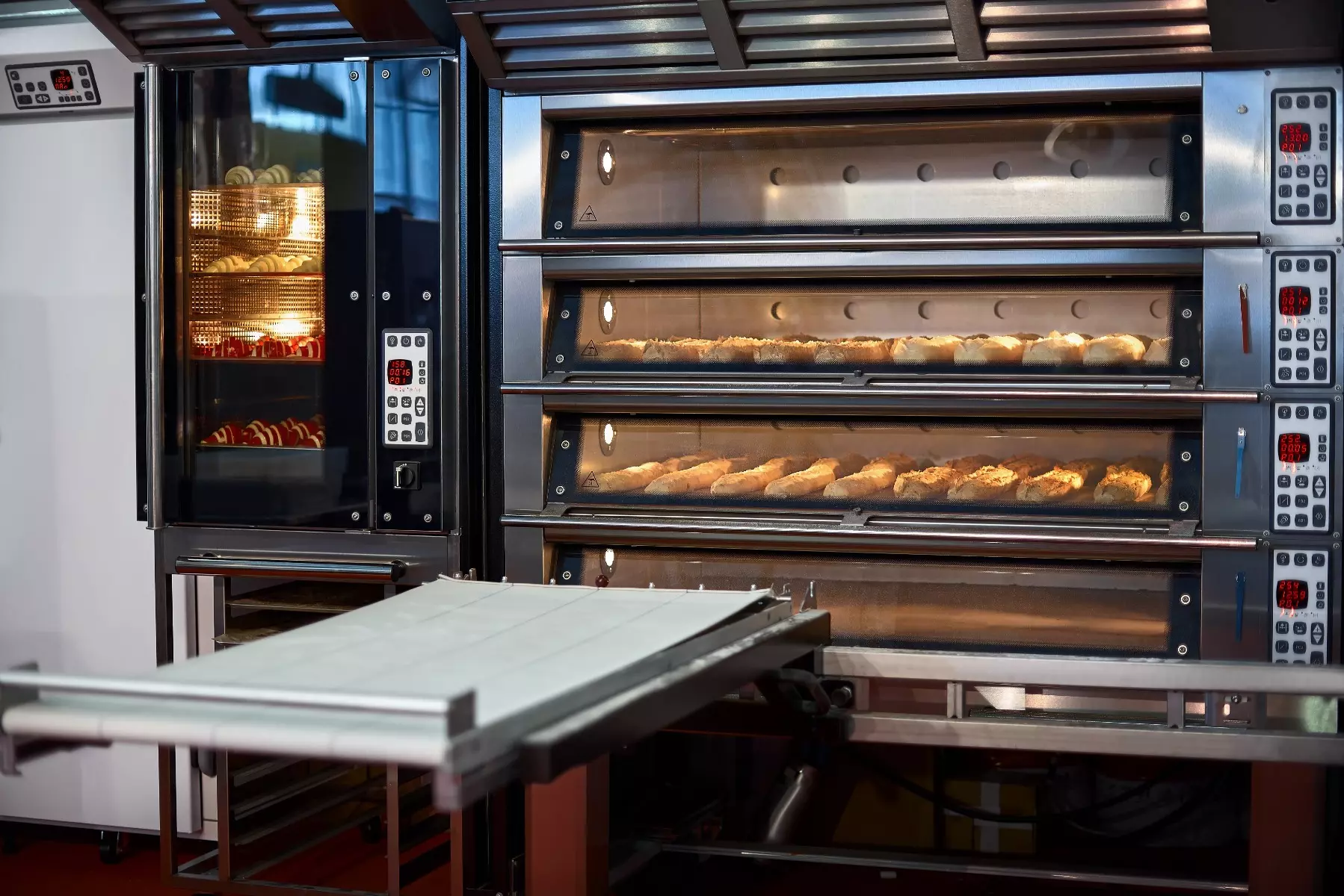 Commercial convection oven with doors open and breads cooking.